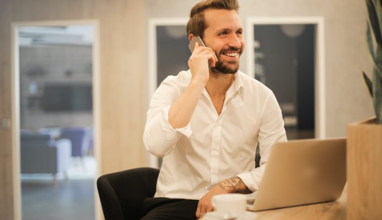 man using smartphone on chair